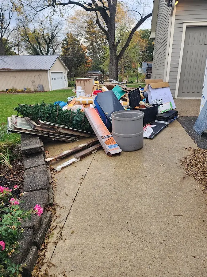 Dumpster being loaded with debris for Estate Cleanout Dumpster Rental in Cockrell Hill